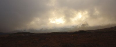 The sun disappearing behind the mountains at Rannoch Moor