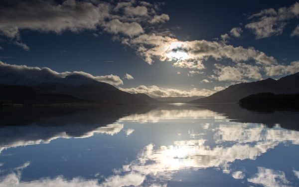 A beautiful winters day on Loch Etive, small boat fishing in mirror calm conditions near Barrs.