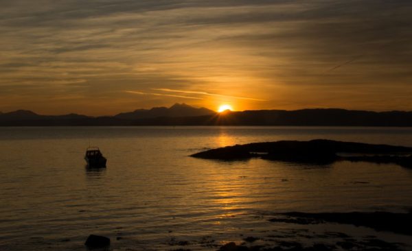 The sun rises over Ben Cruachan with Alcatraz sitting at anchor on Mull