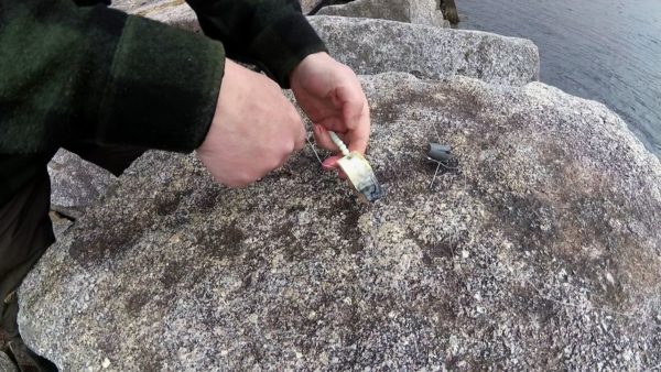 Baiting a pulley rig with mackerel before casting out into the depths of Loch Etive