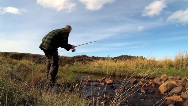 Striking into a small trout in a burn near Cape Wrath