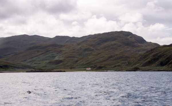 The bothy at Glengarrisdale, Jura, with its red tin roof clearly showing in this shot from the seaward side