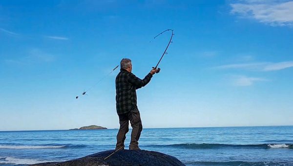 Casting out a couple of baits on a spinning rod and into the crystal clear water of the Atlantic