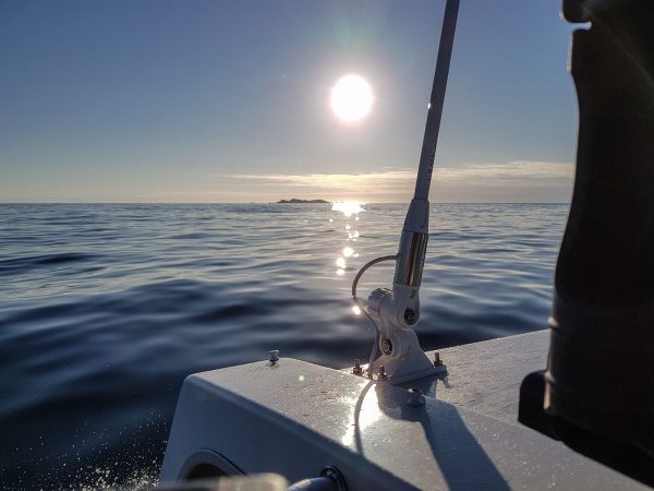 Cruising along a very calm Atlantic as the sun sets over the Torran Rocks, SW Mull