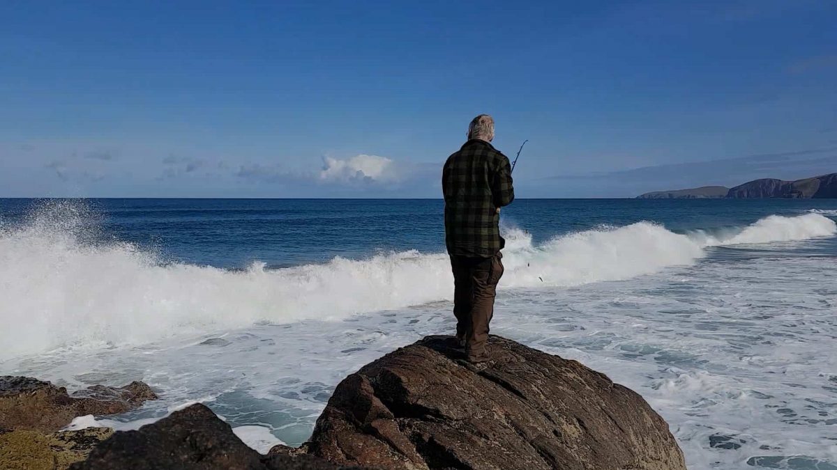 Casting a bait into the surf at Sandwood Bay