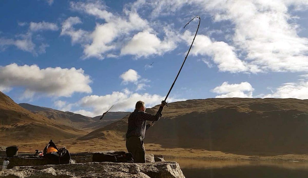 Launching a mackerel bait out into the calm waters of Loch Etive, in search of a spurdog