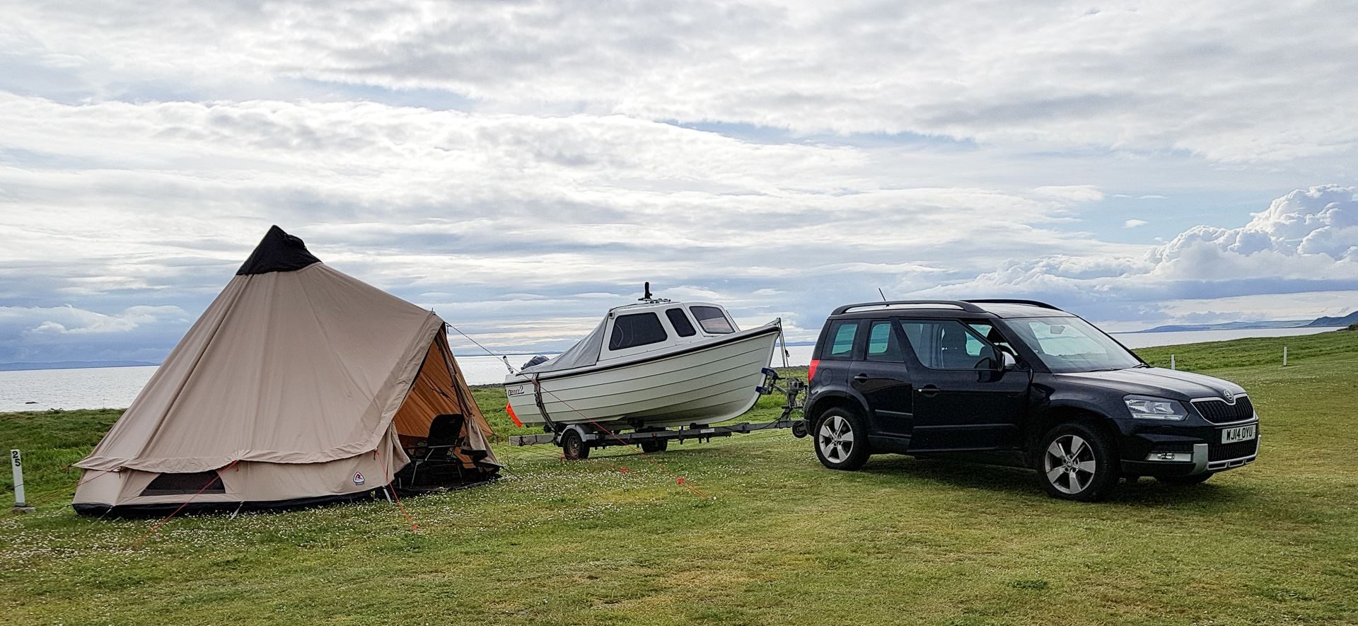 Boat, car and tent setup for the week on the shores of Luce Bay