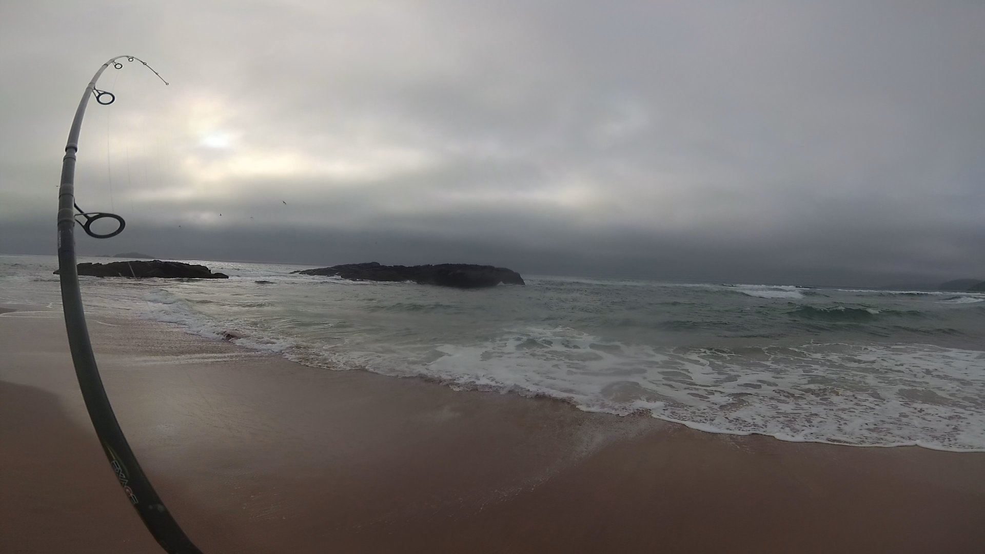 A fish hits my toby lure in the Sandwood Bay surf, putting a nice bend in the rod