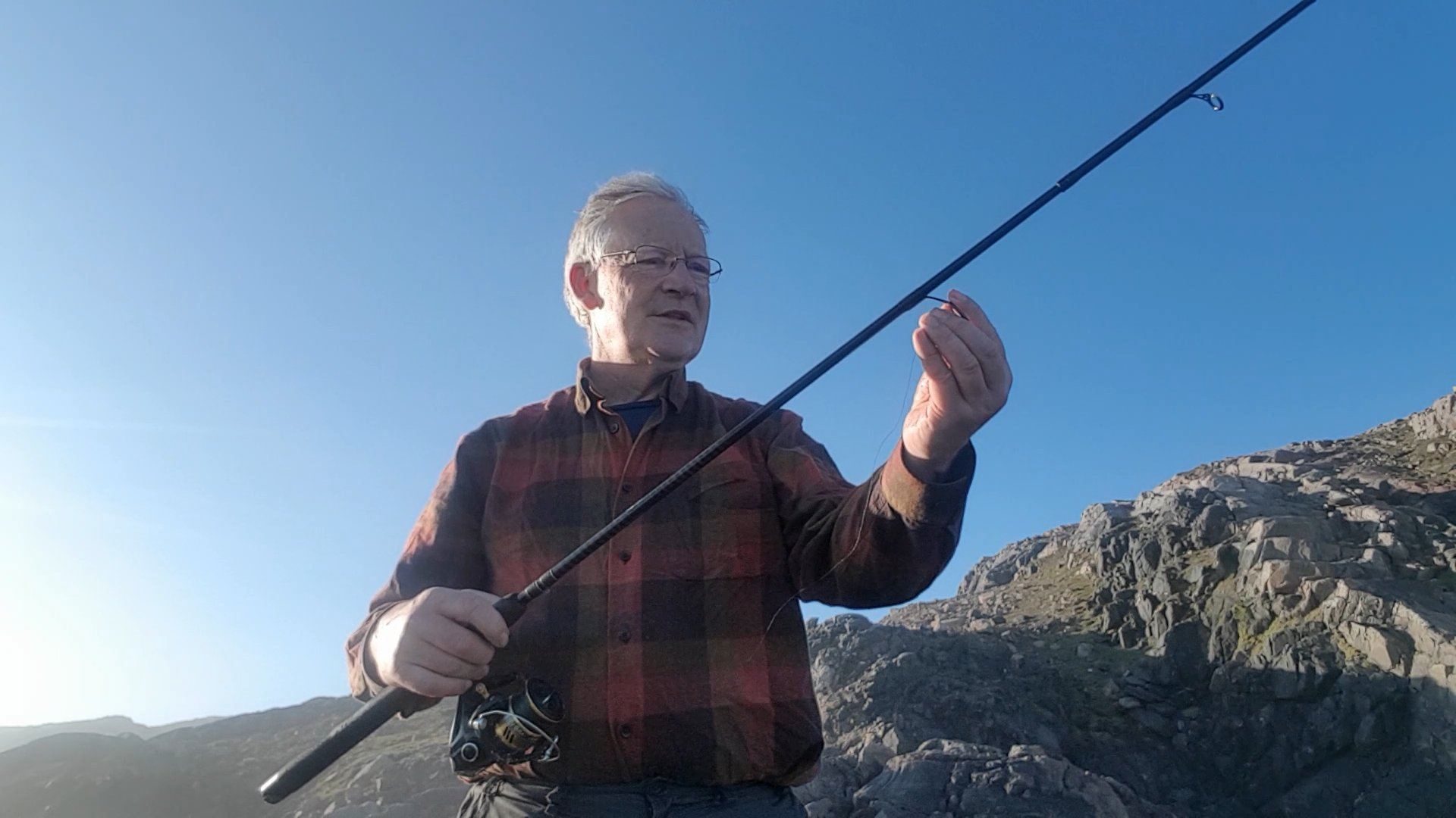 Tackling up for a light sea fishing session with a spinning rod, a few miles south of Cape Wrath, Scotland