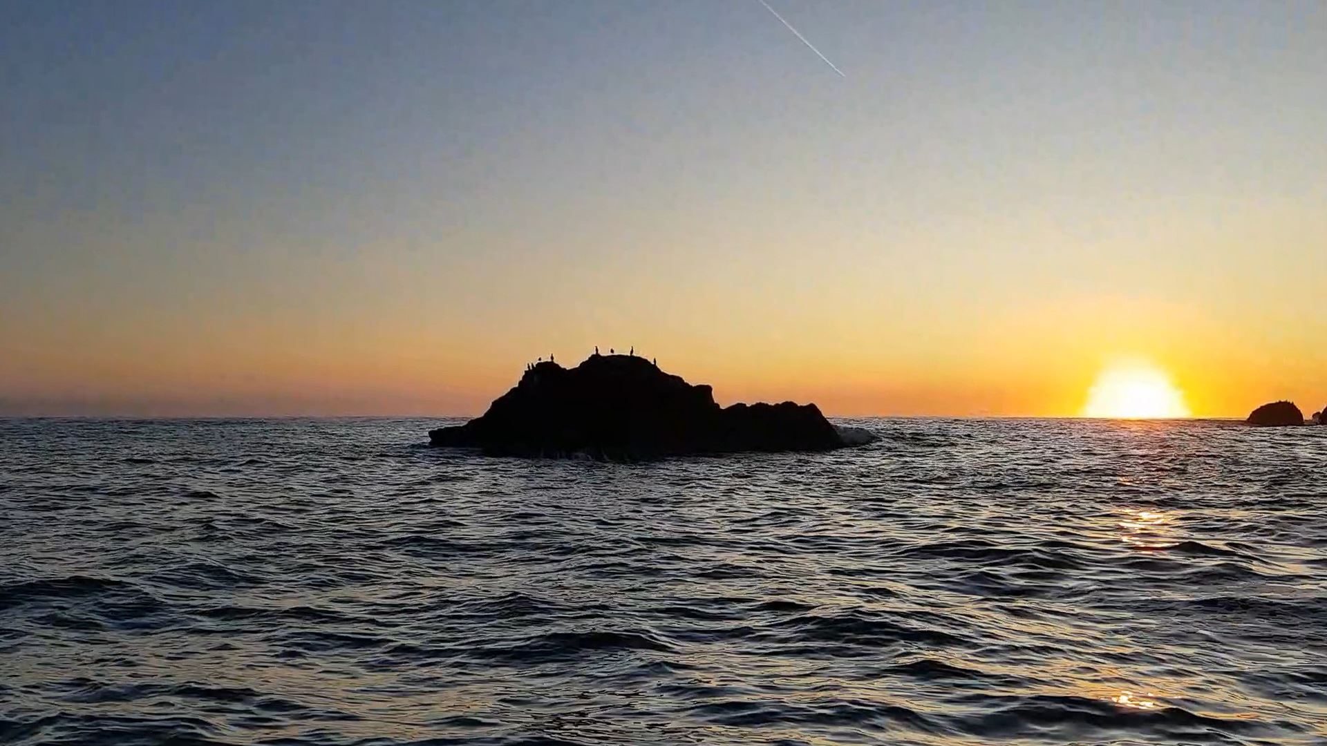 The sun is just appearing above the horizon as I pass the Yett rocks which line the approach to Dunbar harbour